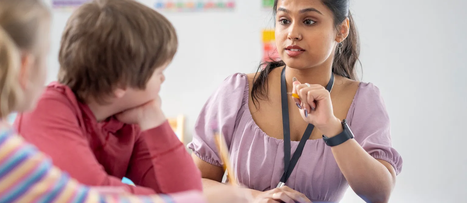 A teacher supporting a pupil